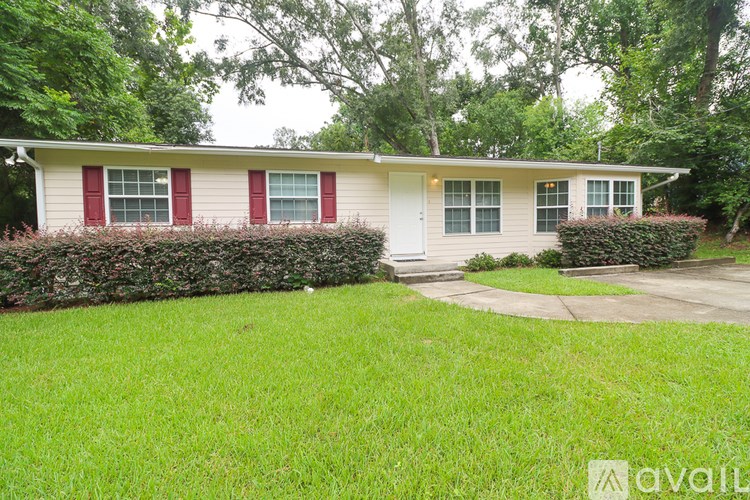 A house with a red window trim is for sale.