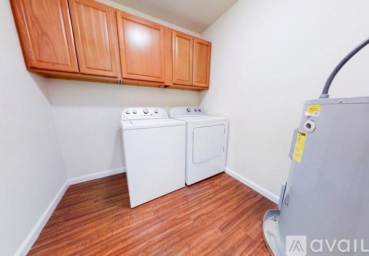 A small laundry room with a washer and dryer.