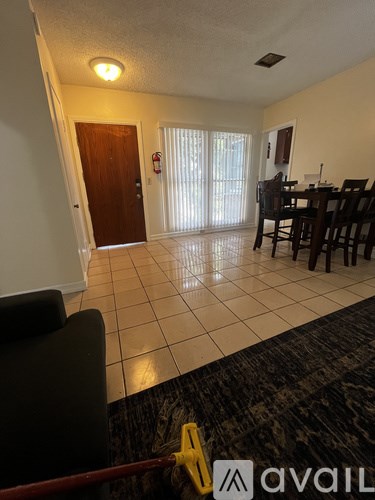 A living room with a dining table and chairs.