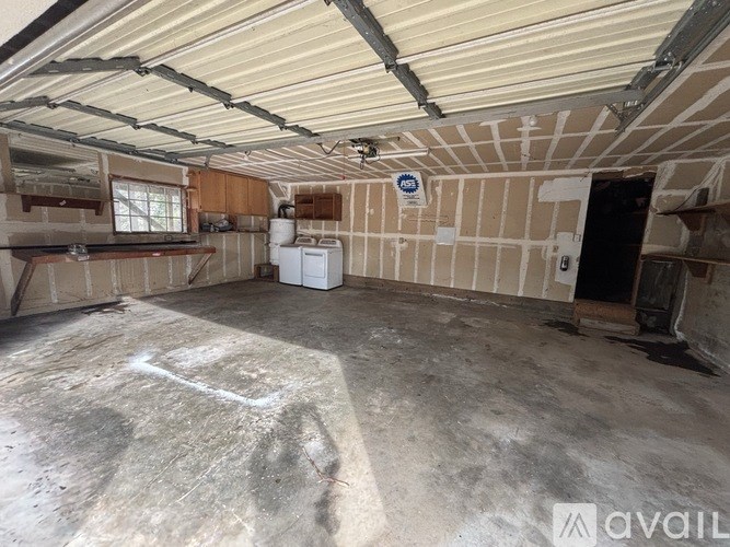 A room under construction with a white washing machine in it.