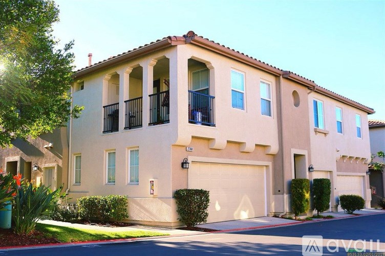 A two-story house with a balcony on the second floor.