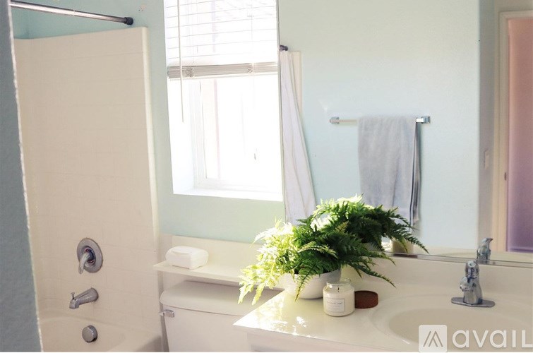 A bathroom with a white sink and a white toilet.