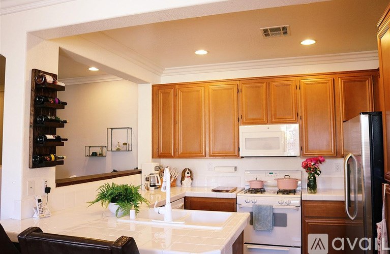 A kitchen with wooden cabinets and a white countertop.