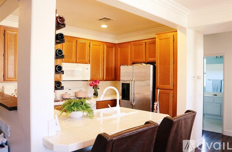 A kitchen with wooden cabinets and a white countertop.