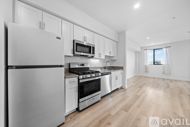 A modern kitchen with white appliances and cabinets.