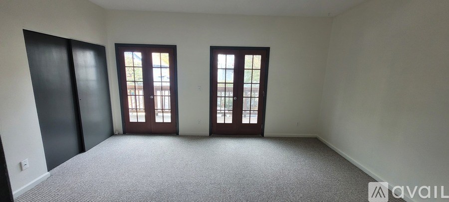 A room with two doors and one window.