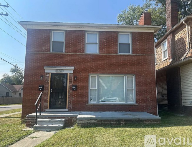 A red brick house with a black door and windows.