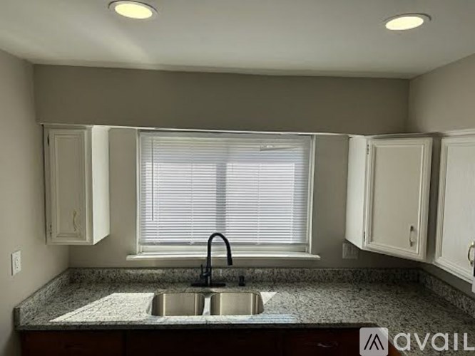 A kitchen with a granite countertop and a sink.