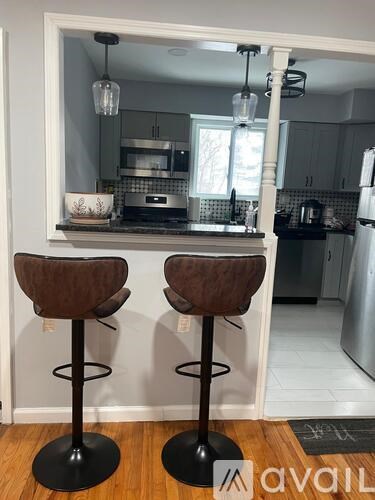 Two bar stools are in front of a kitchen counter.
