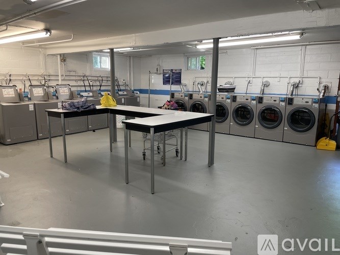 A laundry room with washing machines and a table.