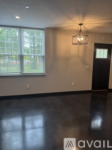 A room with a large window and a chandelier.