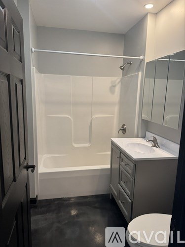 A bathroom with a white sink and a white bathtub.