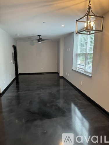 A room with a ceiling fan and a hanging light fixture.