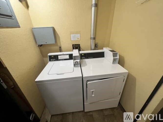 A white appliance with a black handle is in a room with yellow walls.