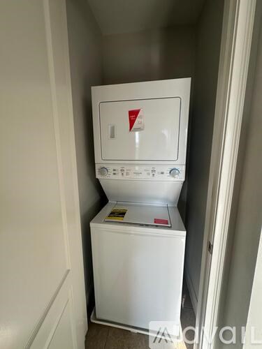 A white washing machine in a small room.