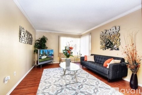 A living room with a grey couch and a coffee table.