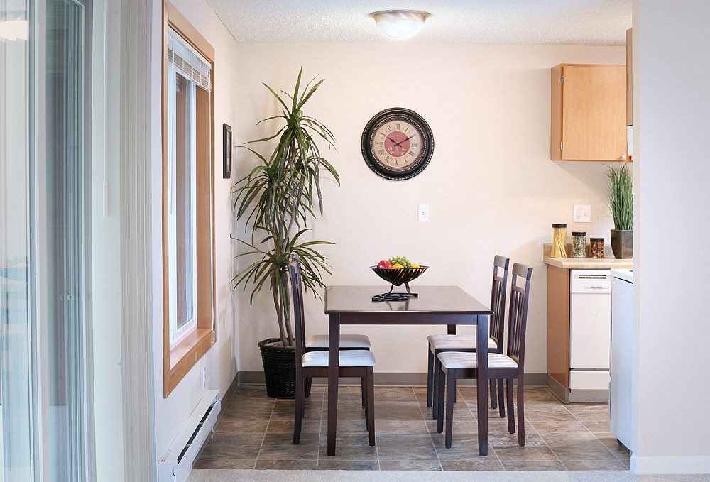 a dining room with a table and chairs in a kitchen