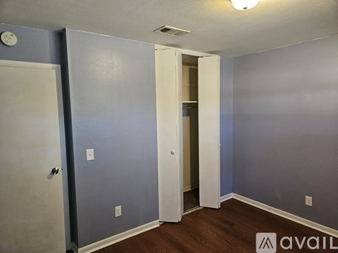 A room with a door and a wall socket.