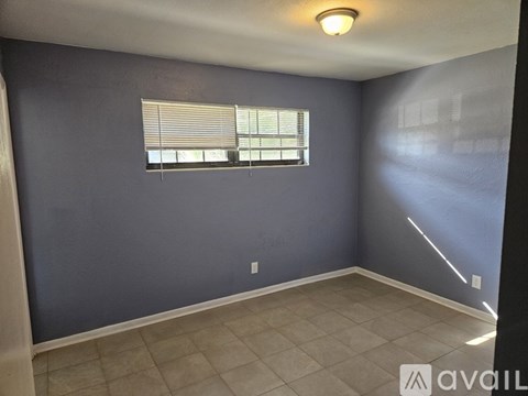 A room with a window and a tiled floor.