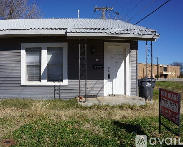 A house with a "For Lease" sign in front of it.