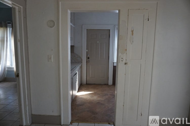 A room with a door and a wall socket.