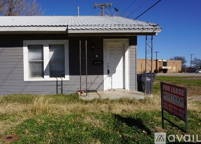 A house with a "For Lease" sign in front of it.