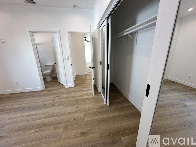 A room with a white door and a white wall.