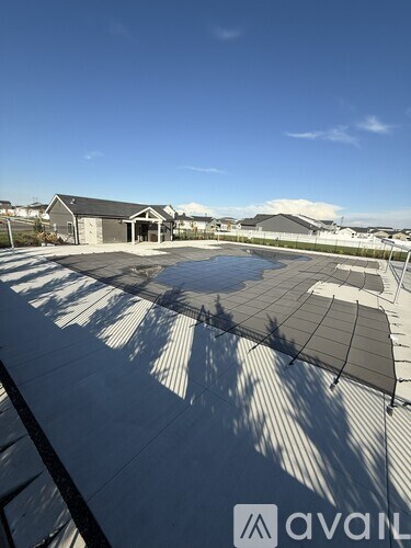 A large building with a pool in the middle of a covered area.