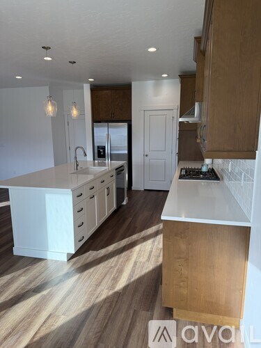 A modern kitchen with wooden cabinets and a white countertop.