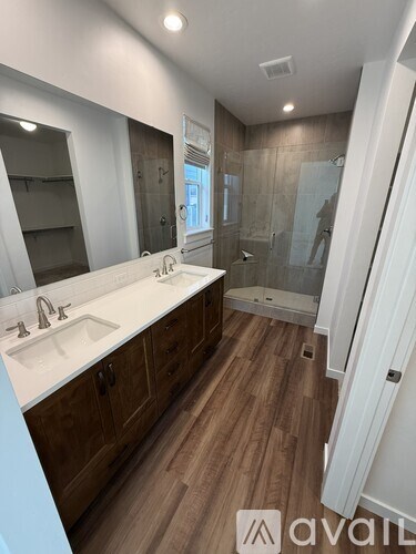 A bathroom with a white countertop and wooden cabinets.