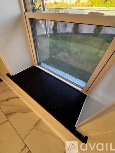 A window with a view of a green area outside.