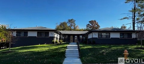 A house with a sign that says "AVAIL" in front of it.