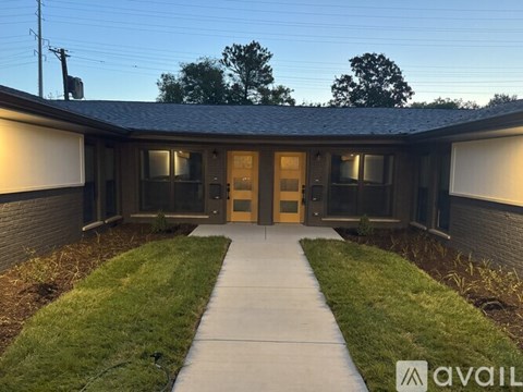 A building with a walkway leading to the front door.