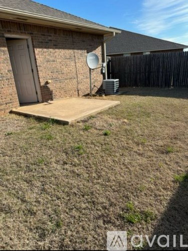 A satellite dish is mounted on a wall outside a house.