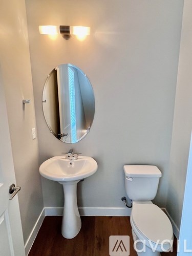 A white sink and toilet in a small bathroom.