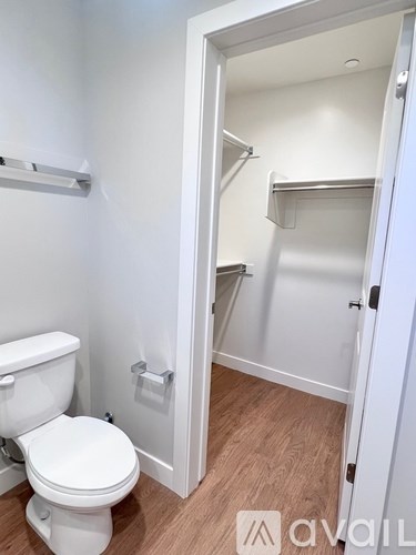 A white toilet in a small room with a white door.
