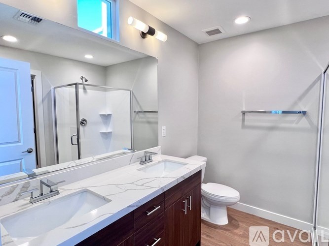 A bathroom with a white countertop and a white toilet.
