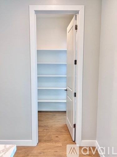 A white door with a shelf underneath it.