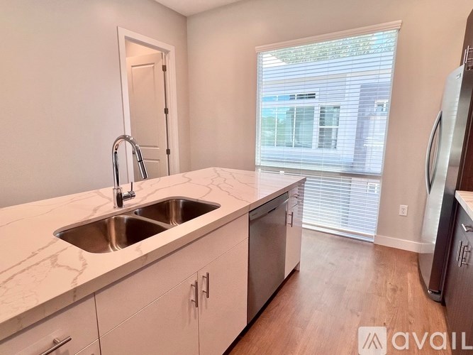 A kitchen with a sink and a window.