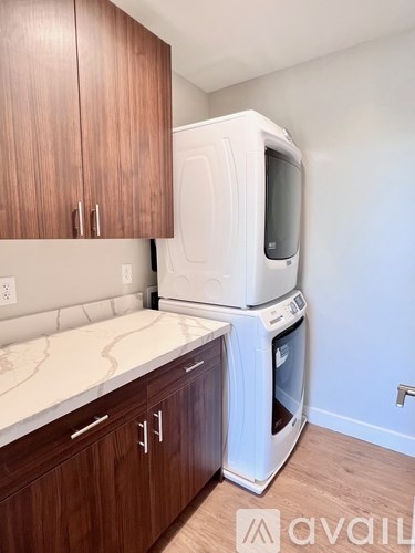 A kitchen with brown cabinets and a white oven.