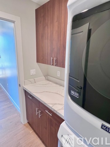 A kitchen with wooden cabinets and a white dishwasher.