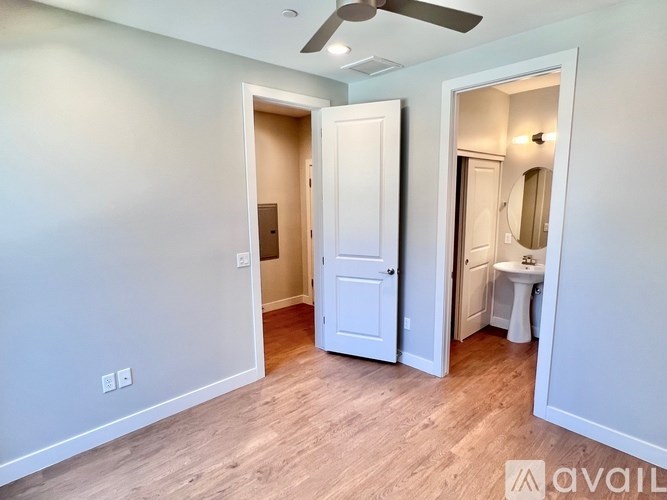 A room with a white door and a white sink.