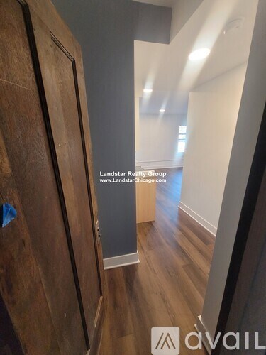 A hallway with a sign that says "Landstar Realty Group" and a website address.