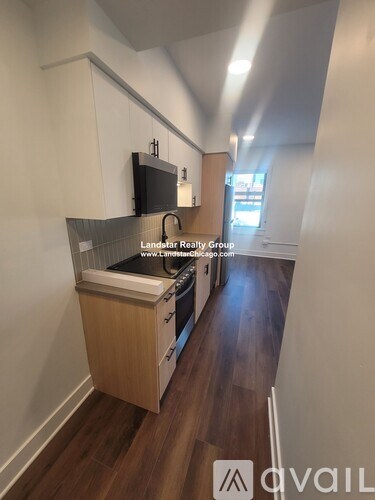 A kitchen area with wooden floors and a countertop.