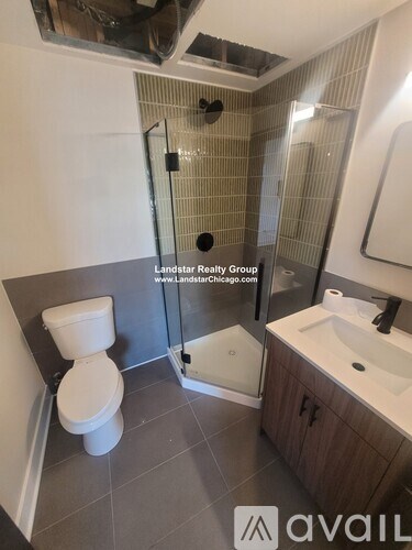 A bathroom with a toilet, sink, and shower.