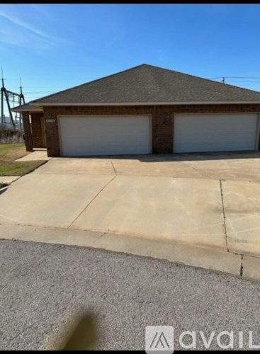 A two-car garage with a brown roof and white doors.