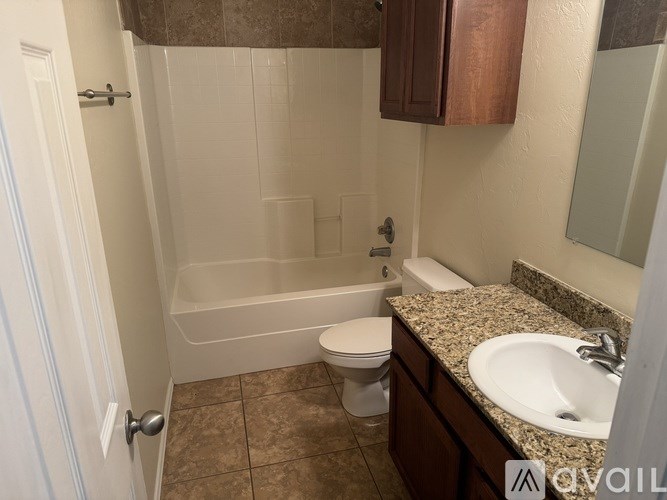 A bathroom with a toilet, sink, and bathtub.