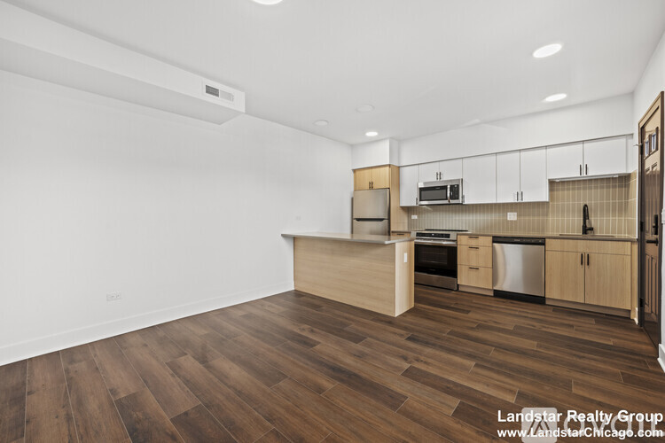 A room with wooden flooring and a ceiling fan.