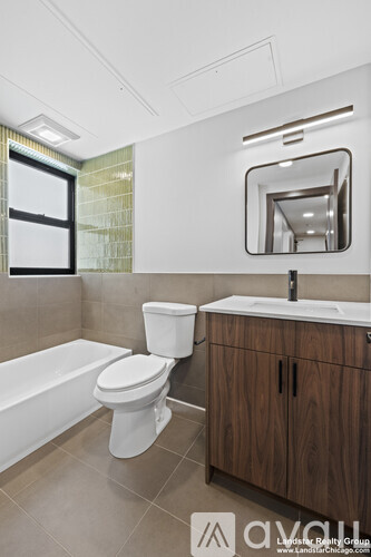 A Landstar Realty Group sign is on a wall above a washer and dryer.
