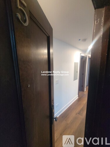 A hallway with a door numbered 5 and a logo for Avail.